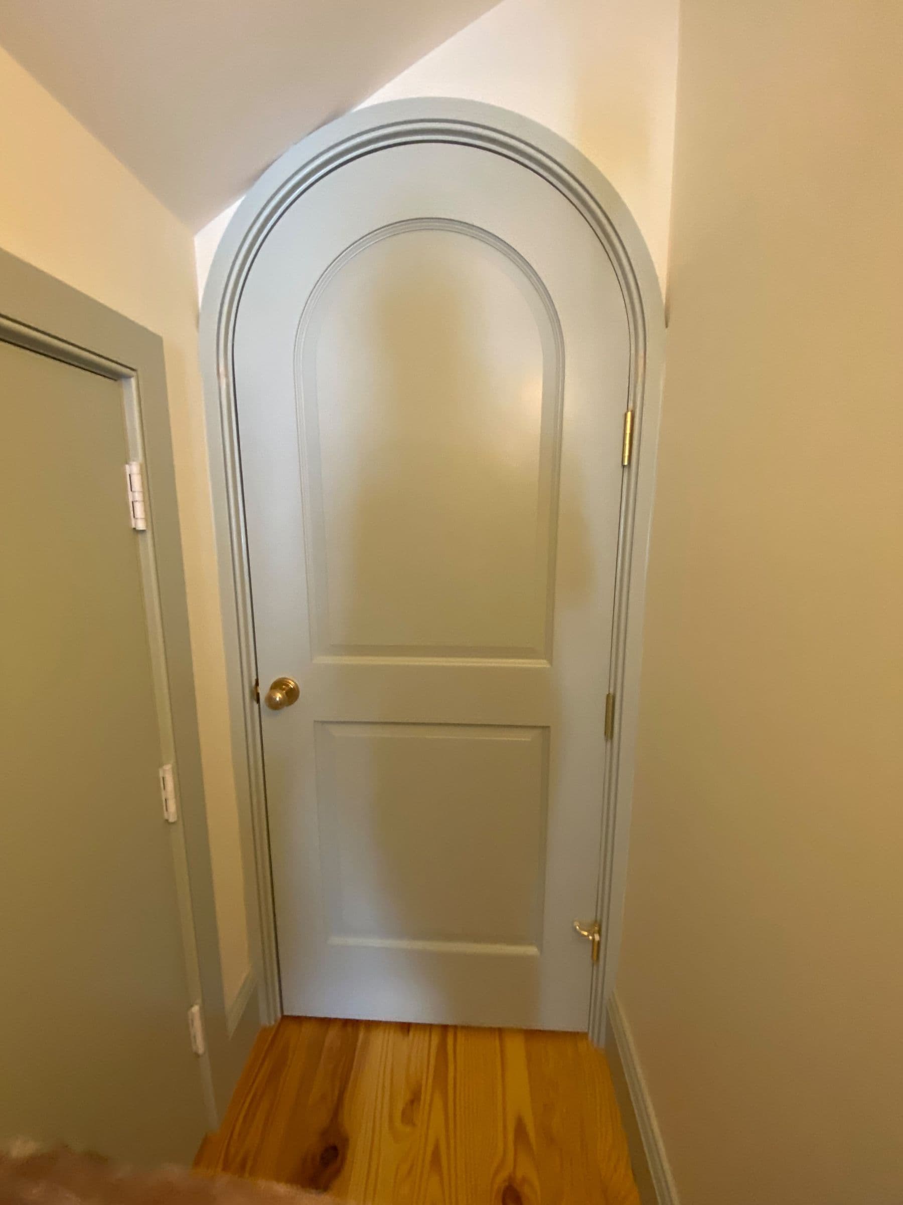 Arched-top door with arched casing on a heart pine floor