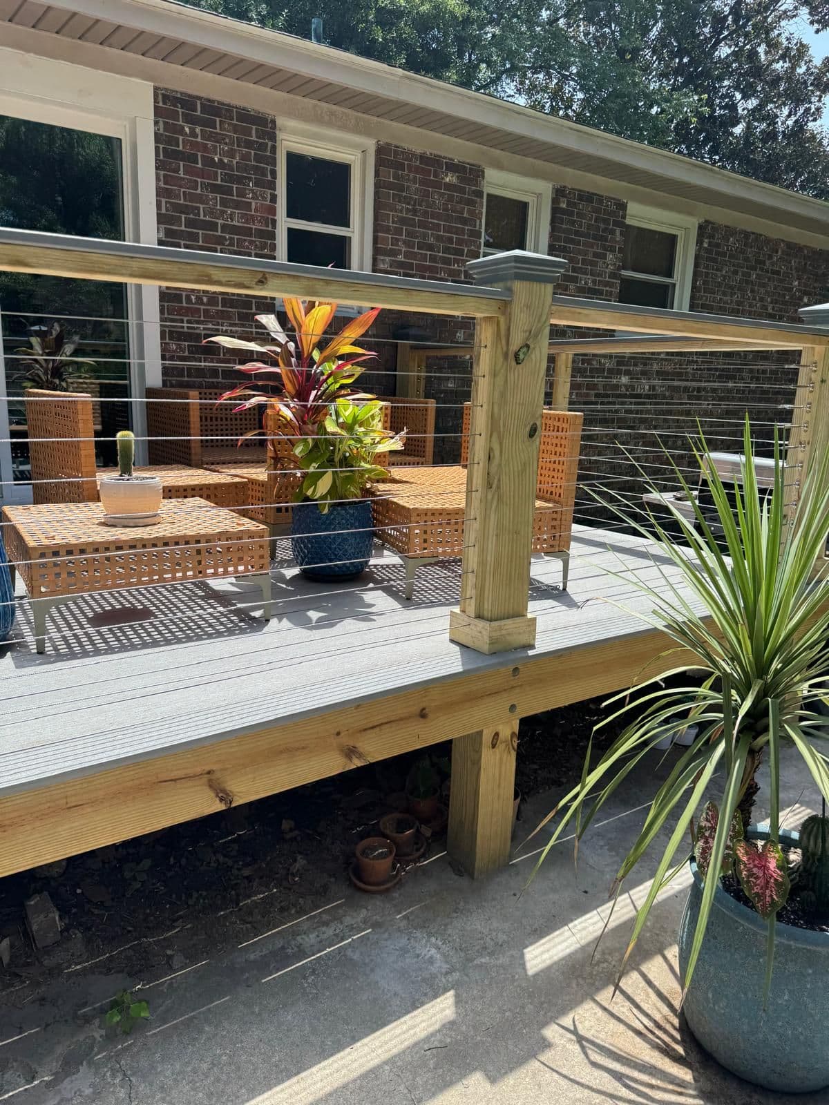 Composite deck with cable railing and potted plants