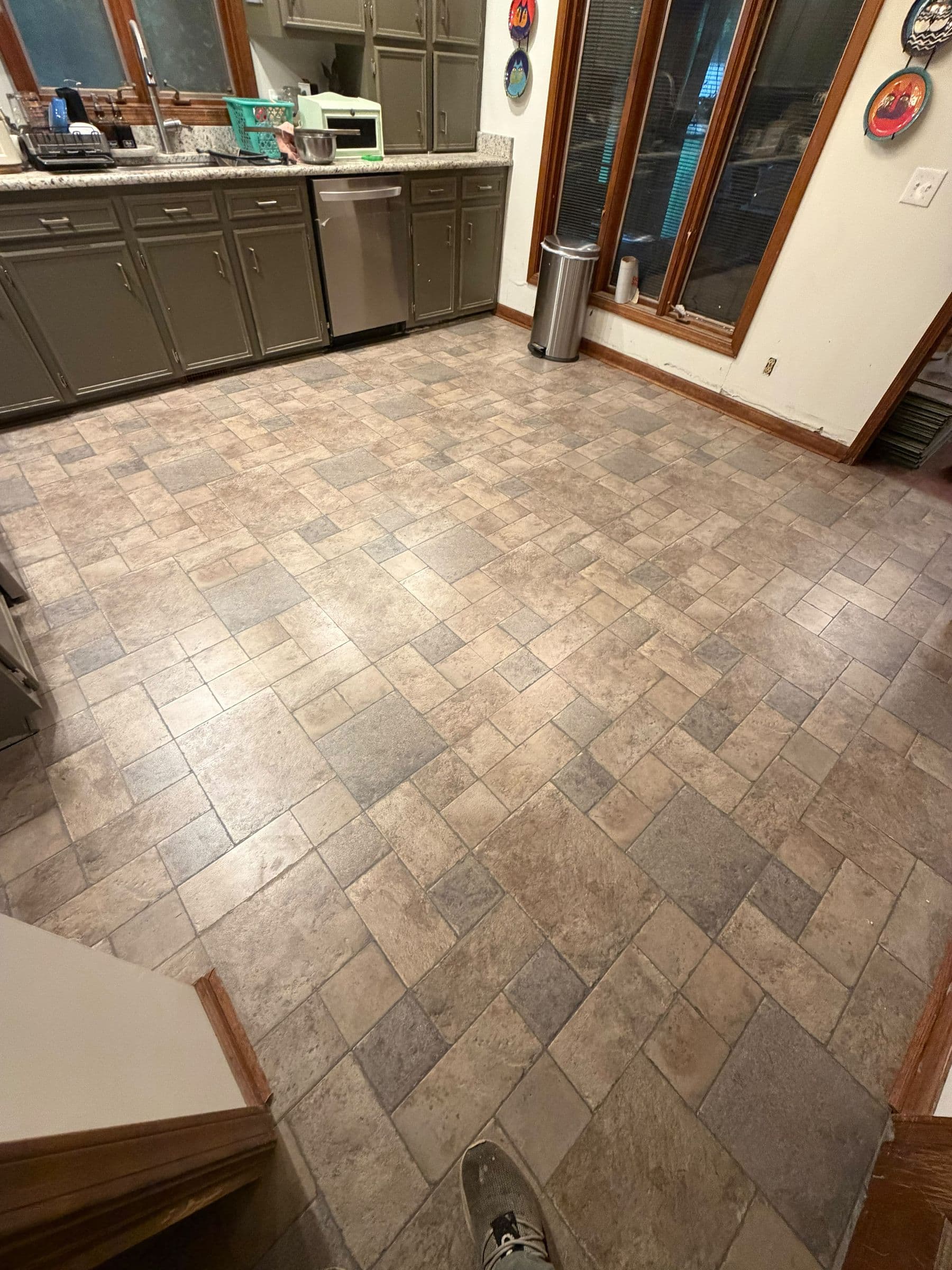 New tile floor through a renovated kitchen