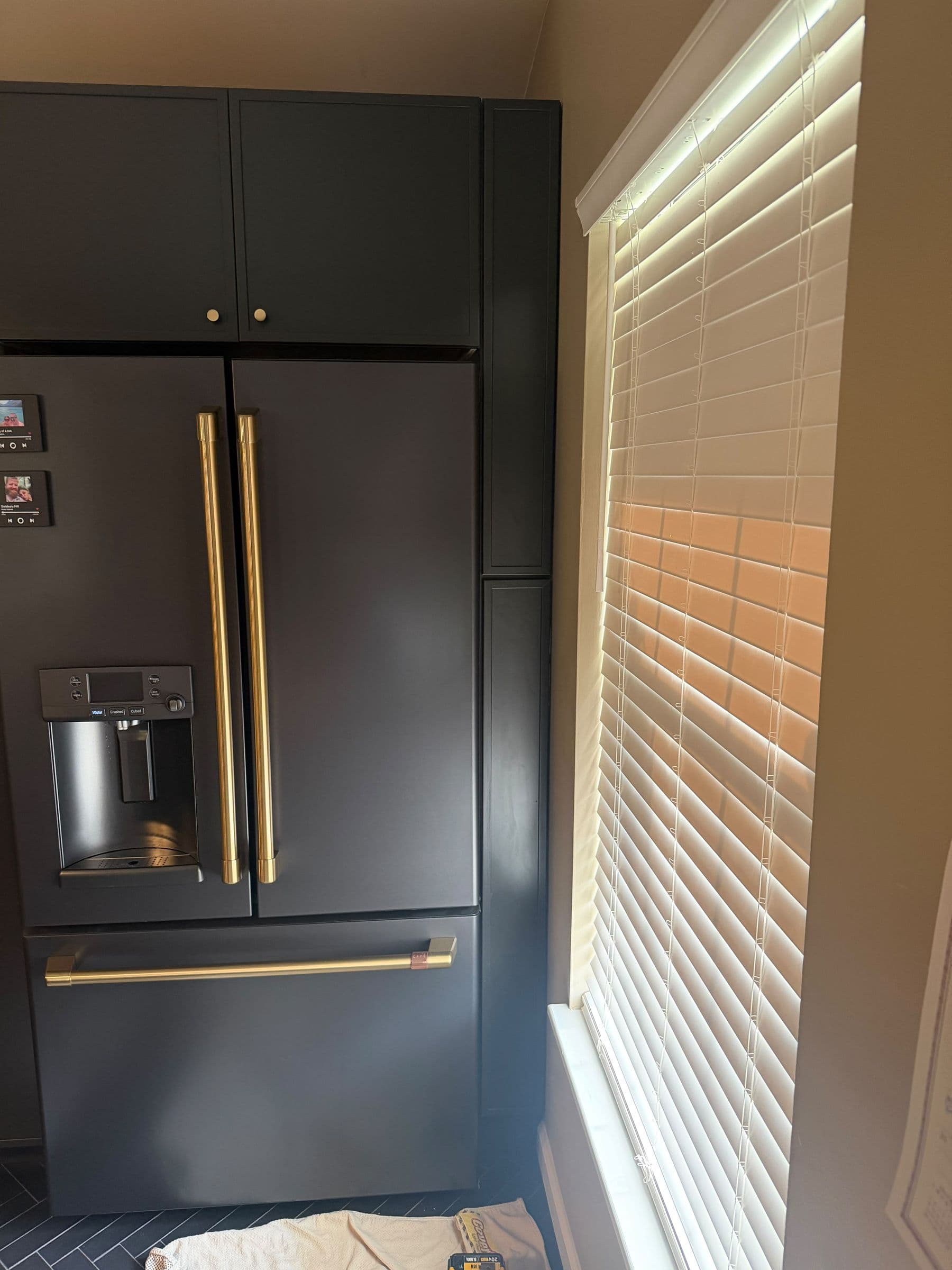 Kitchen with dark cabinetry and a panel-ready refrigerator