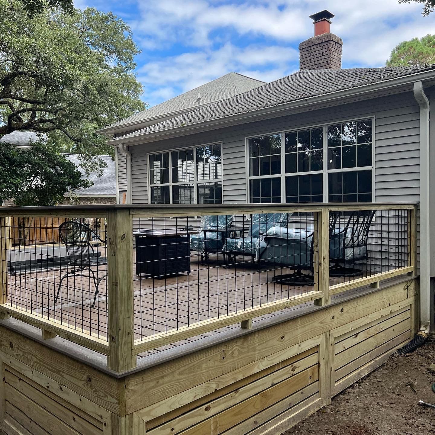 Pressure-treated deck with wire-panel railing and horizontal skirting