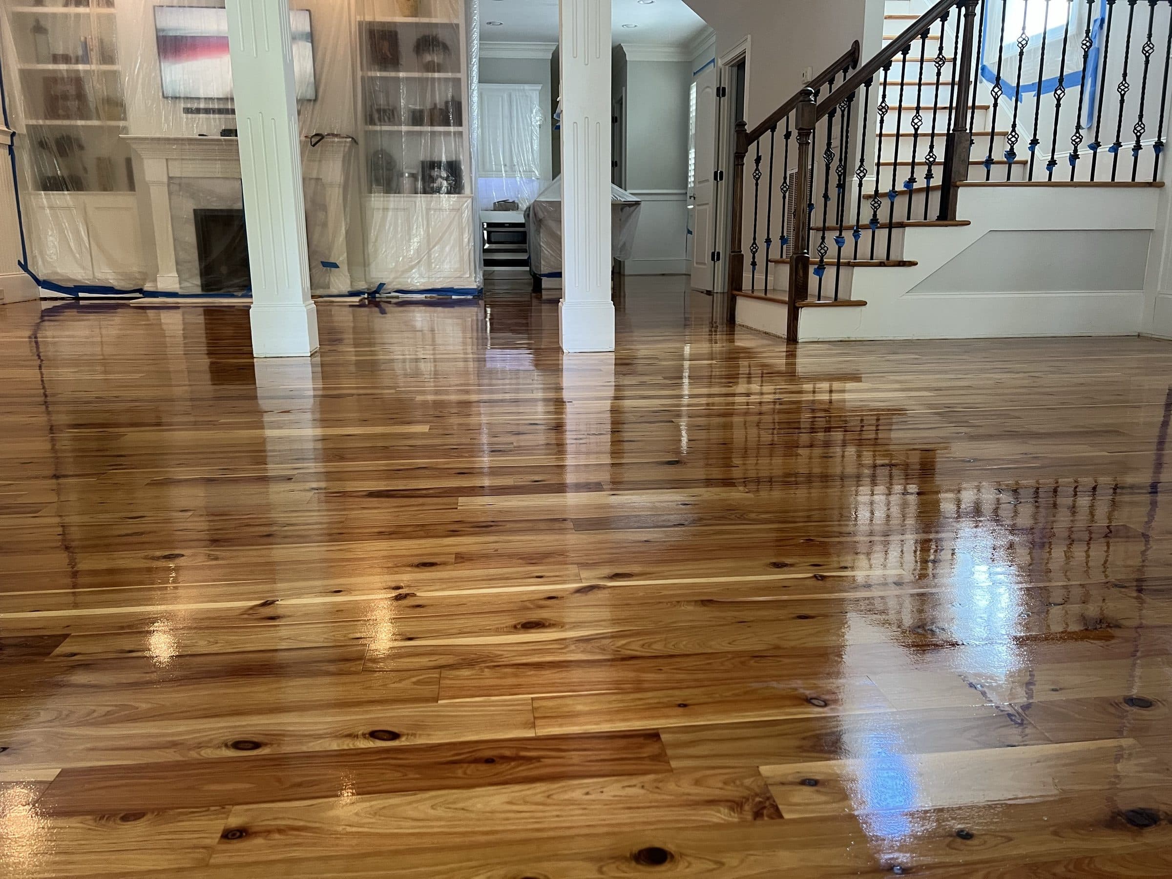Refinished heart pine floor with a high-gloss finish through an open living area