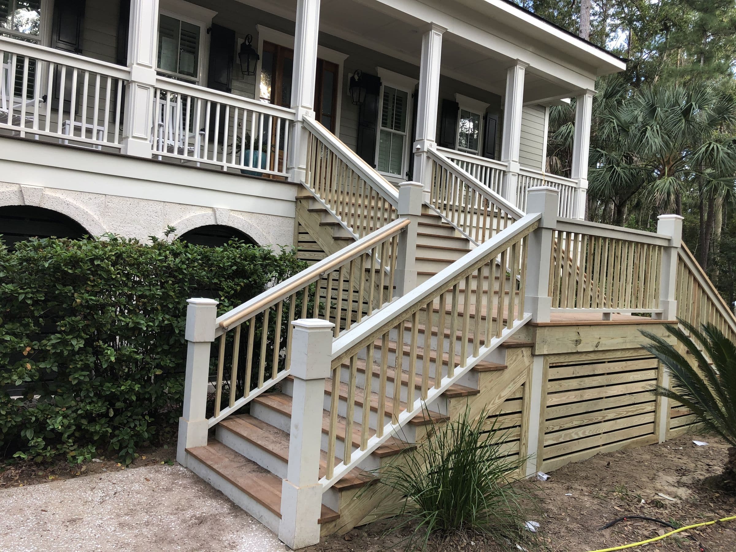 Rebuilt porch stairs and railings on a raised Lowcountry house