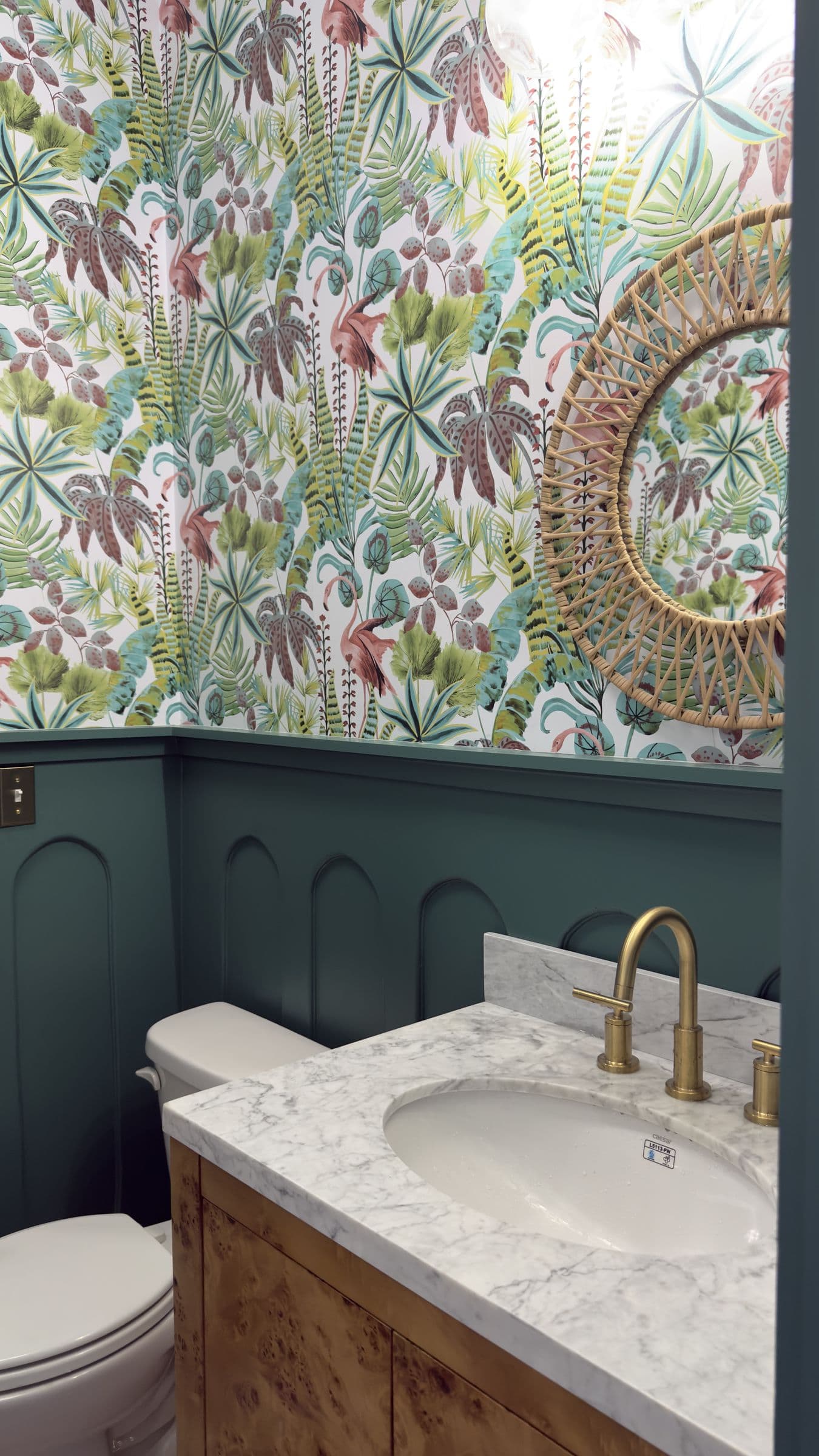 Powder room with arched green wainscot panels