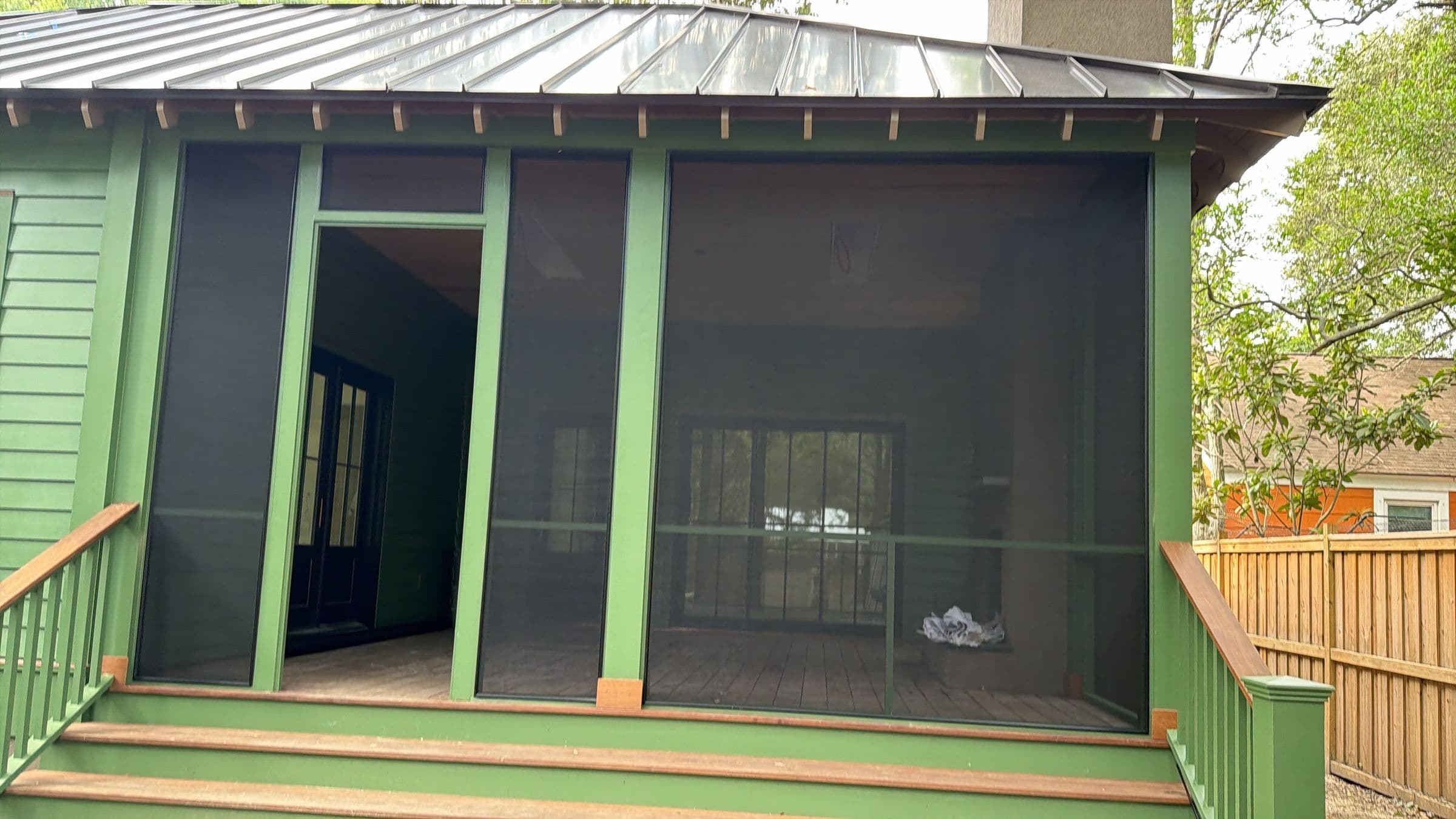 Screened porch with green-painted trim and a new stoop