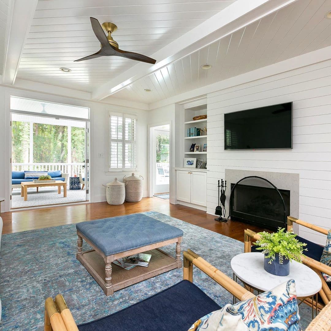 Living room with a shiplap ceiling, built-ins and fireplace