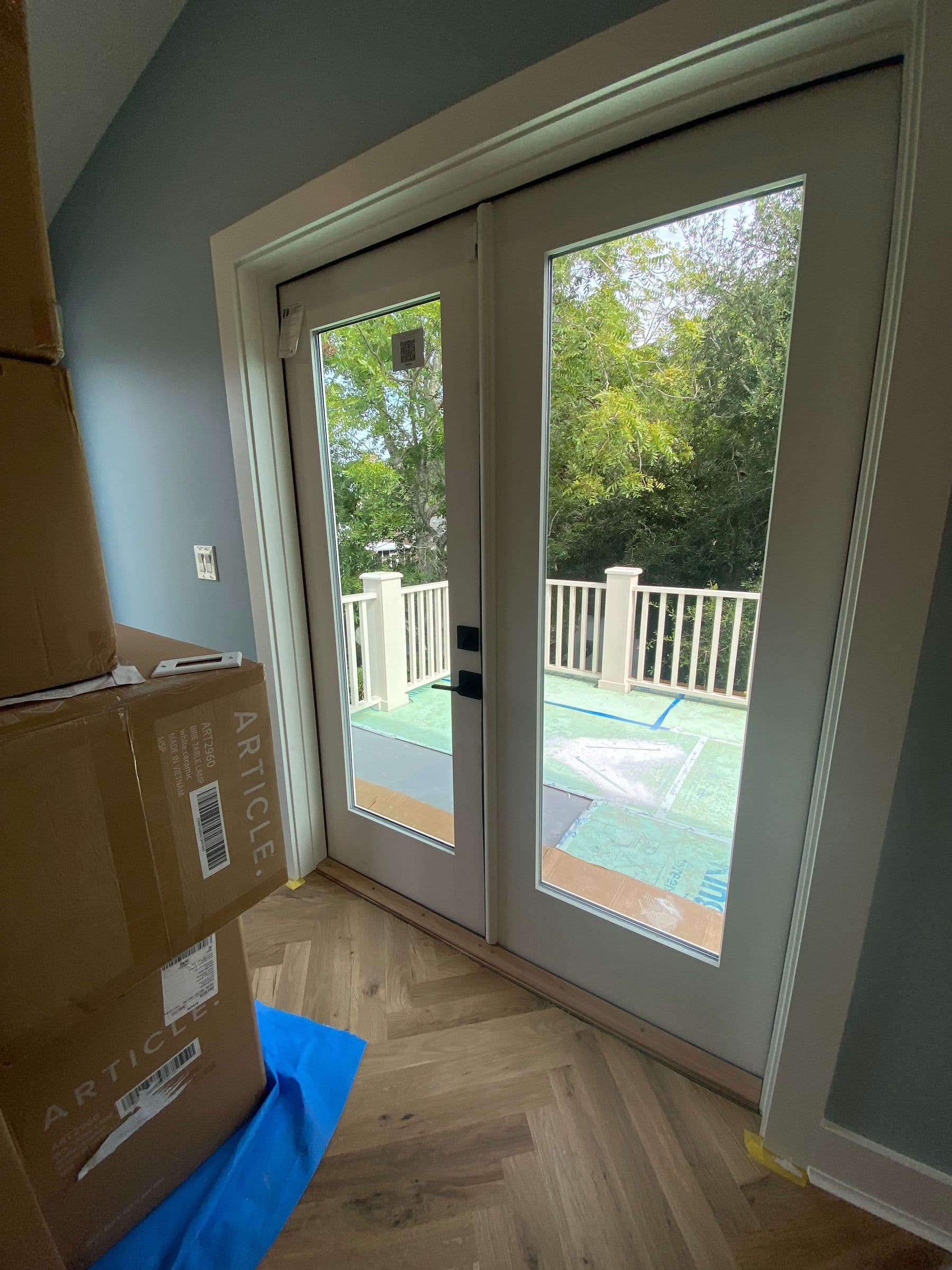 Wide sliding glass doors over a wood deck