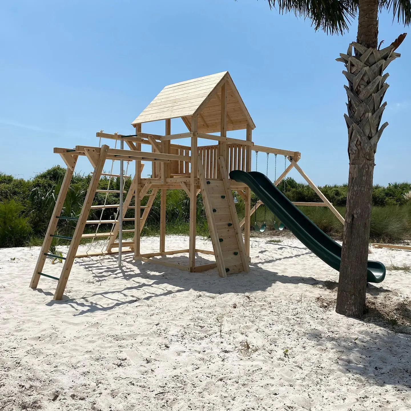 Custom carpentry made kids playhouse outside.